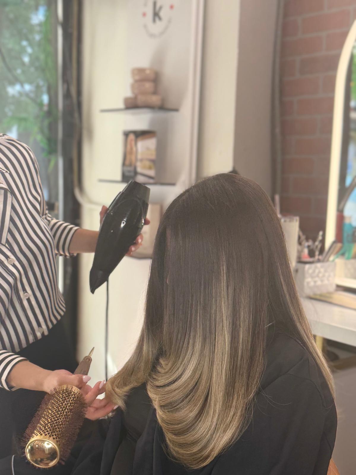 Beautiful woman with professional makeup and sleek hairstyle transformation